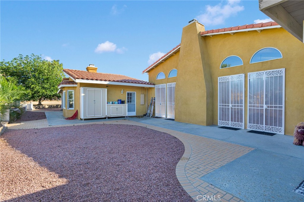 15023 Genesee Road Apple Valley, CA 92307 - Photo 37 of 61 a view of a house with backyard and trees