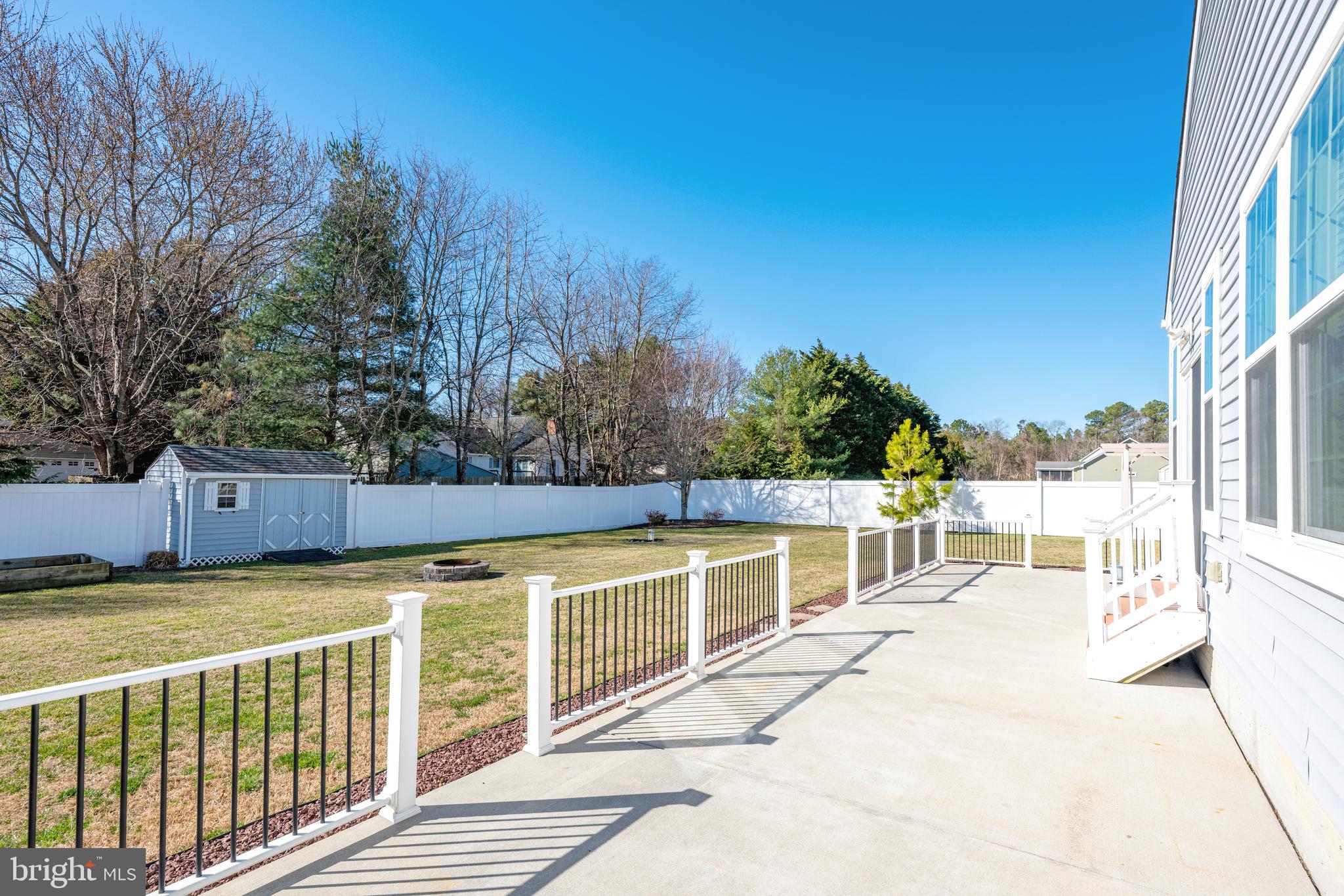33057 Short Road Lewes, DE 19958 - Photo 33 of 40 a view of a swimming pool with a lounge chair
