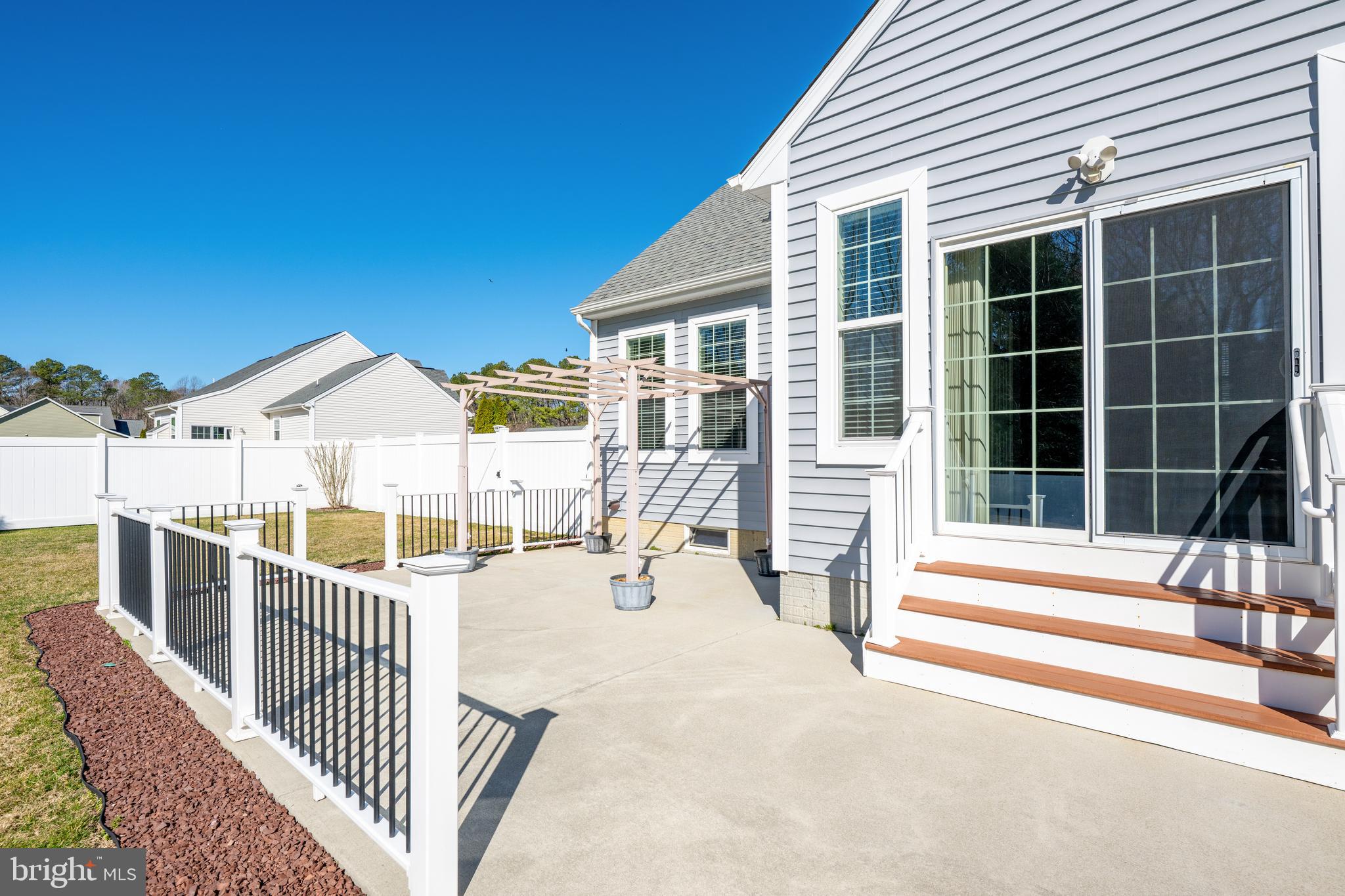 33057 Short Road Lewes, DE 19958 - Photo 34 of 40 a view of a house with a wooden deck and a floor to ceiling window
