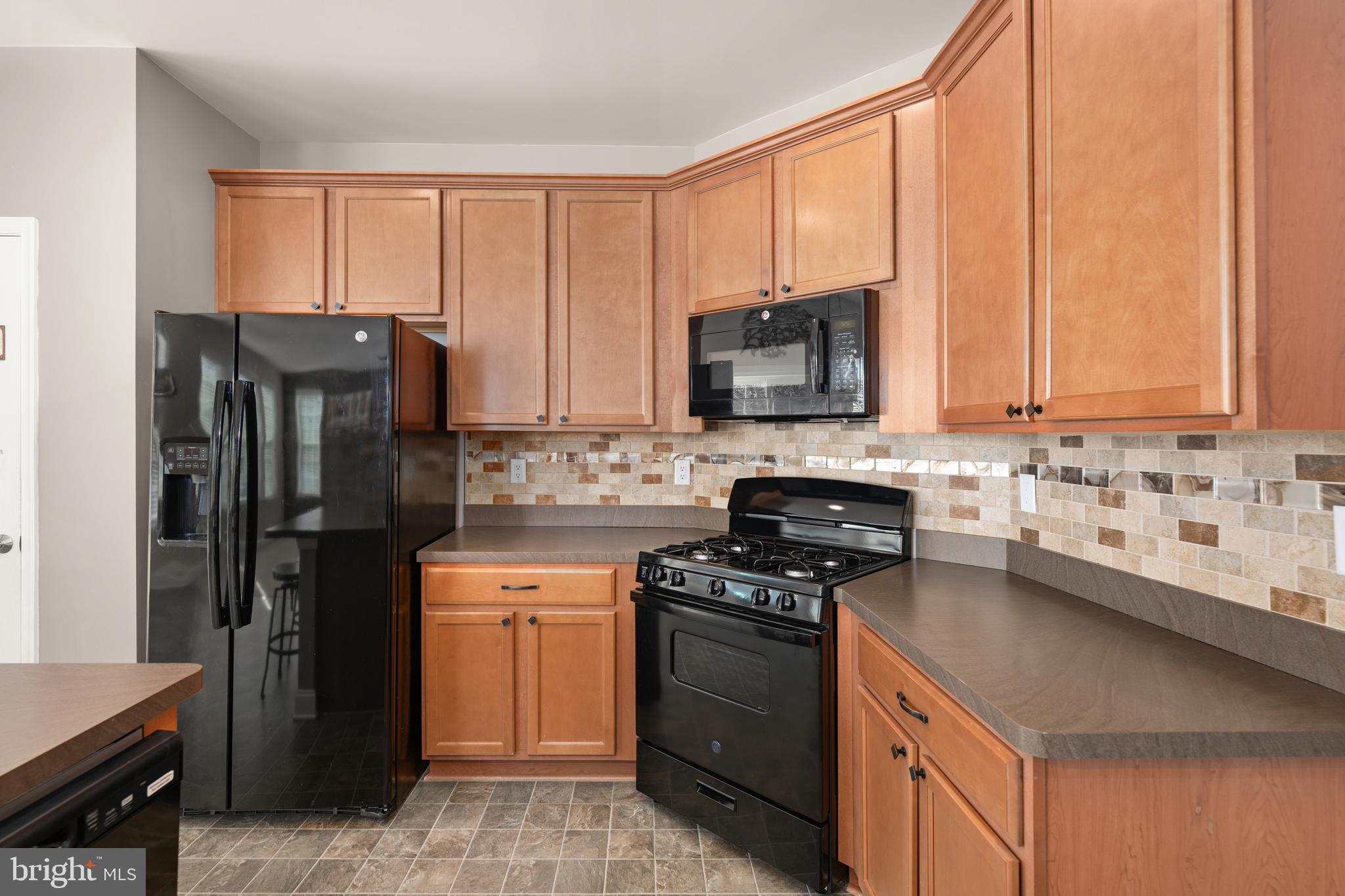 33057 Short Road Lewes, DE 19958 - Photo 6 of 40 a kitchen with a stove a sink and a microwave