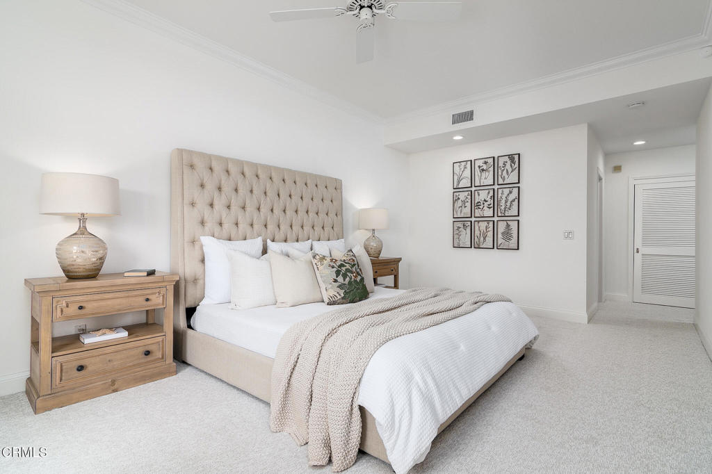 101 Rios Court Solana Beach, CA 92075 - Photo 24 of 67 a bedroom with a bed and a lamp