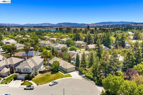 an aerial view of residential houses with outdoor space and street view