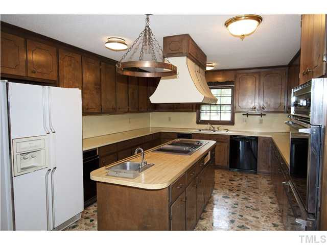 4317 Jimmy Rogers Road Durham, NC 27703 - Photo 19 of 25 Enormous kitchen with center island, two door oven, two trash compactors, new dishwasher, cabinets galore. Kitchen