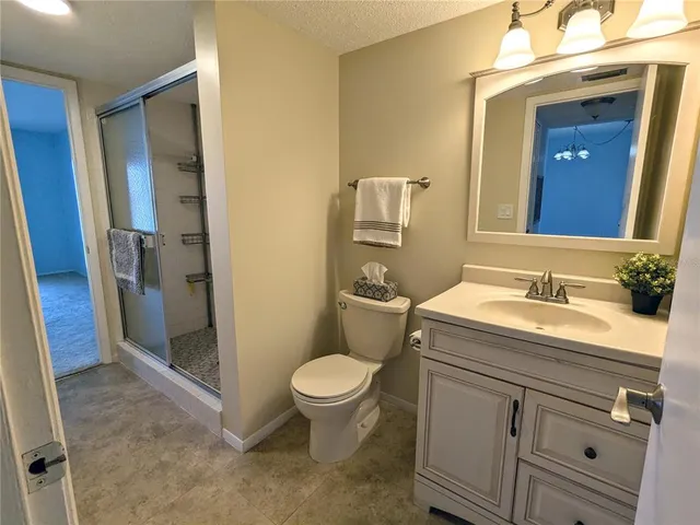 a bathroom with a sink toilet and mirror