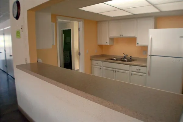 a living room with lots of furniture and kitchen view
