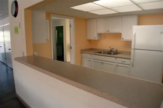a living room with lots of furniture and kitchen view