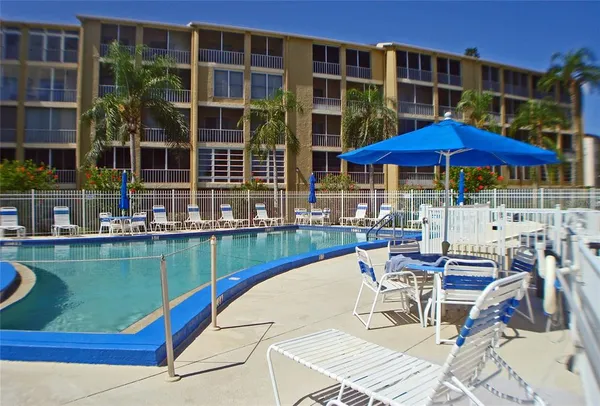 a view of a swimming pool with outdoor seating