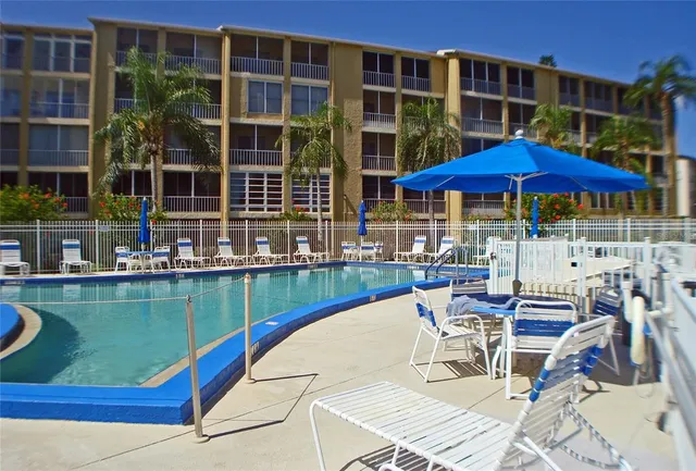 a view of a swimming pool with outdoor seating
