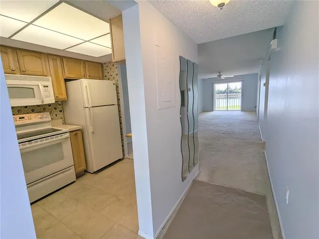 a view of a refrigerator in kitchen and wooden floor