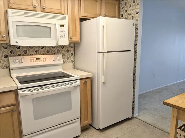 a white refrigerator freezer sitting inside of a kitchen