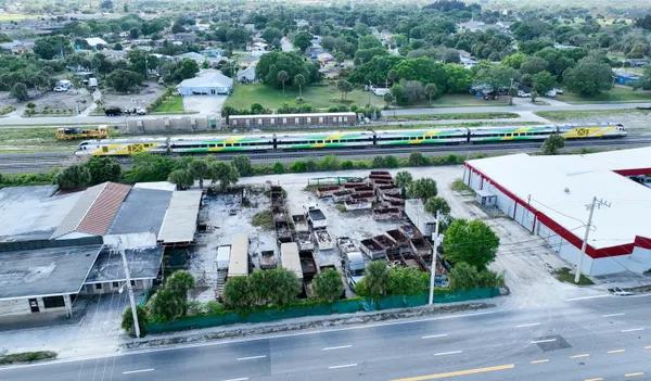 an aerial view of a house with a yard basket ball court and outdoor seating