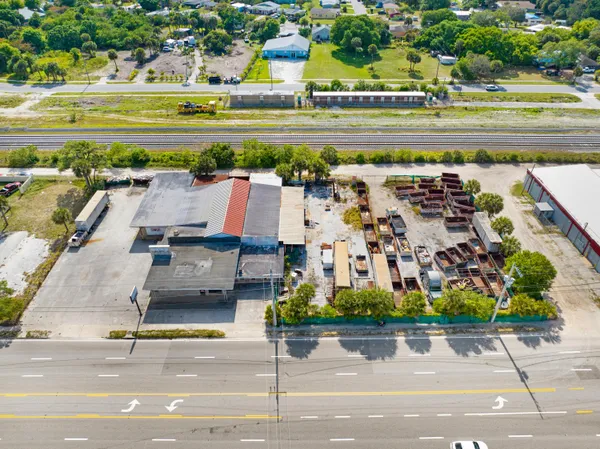 an aerial view of a city with lawn chairs and a swimming pool