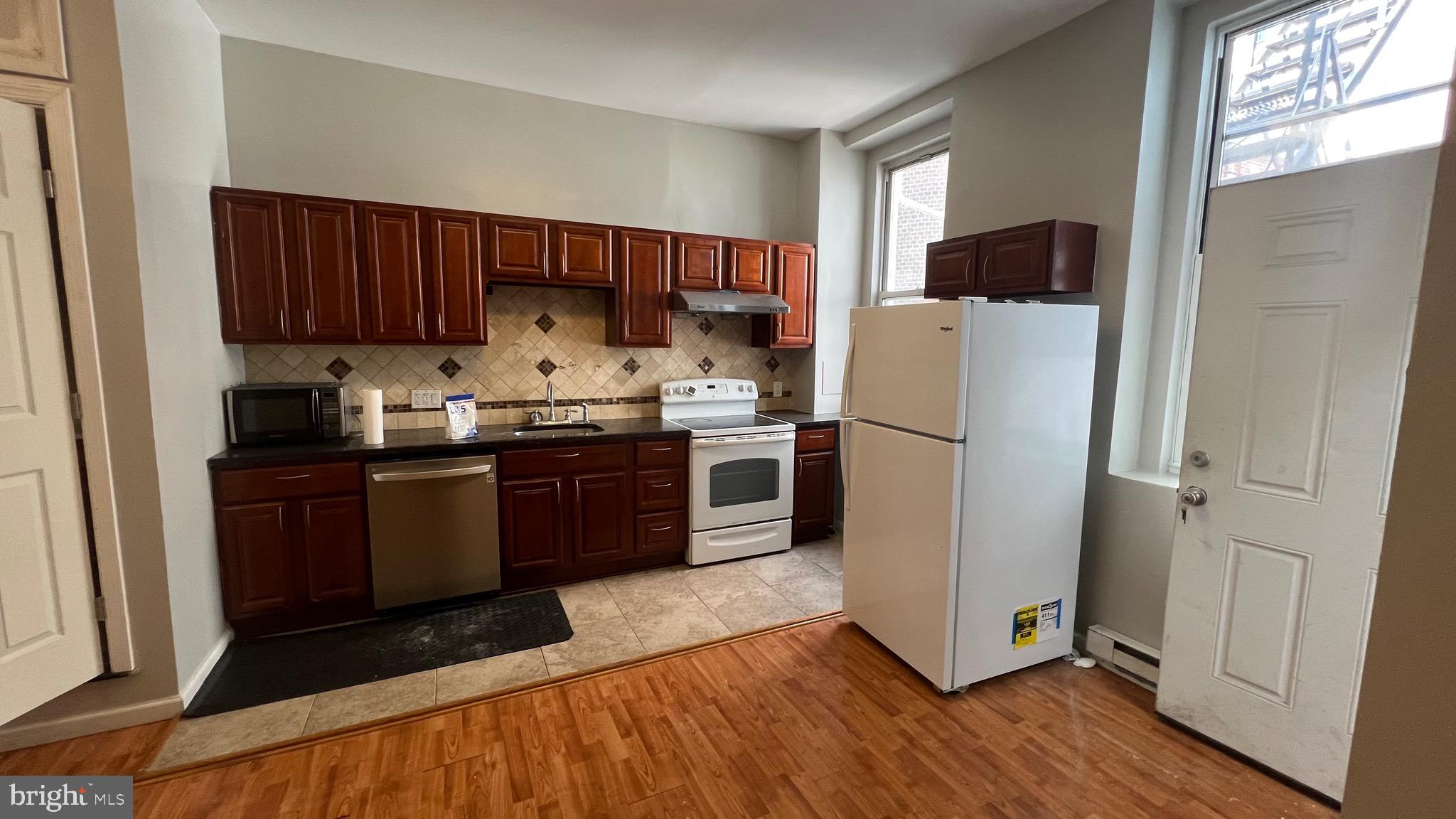 1115 Walnut Street, Unit 2F Philadelphia, PA 19107 - Photo 13 of 14 a kitchen with a refrigerator sink and cabinets