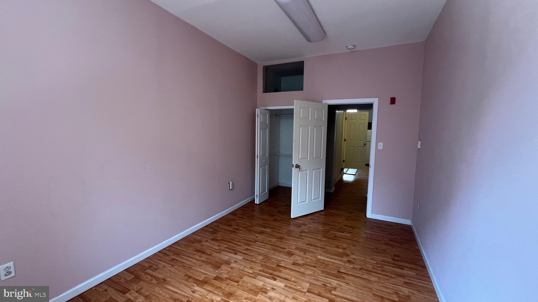 1115 Walnut Street, Unit 2F Philadelphia, PA 19107 - Photo 7 of 14 a view of an empty room with closet and wooden floor