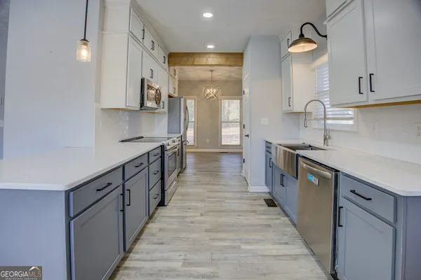 a kitchen with stainless steel appliances granite countertop lots of counter space and a sink