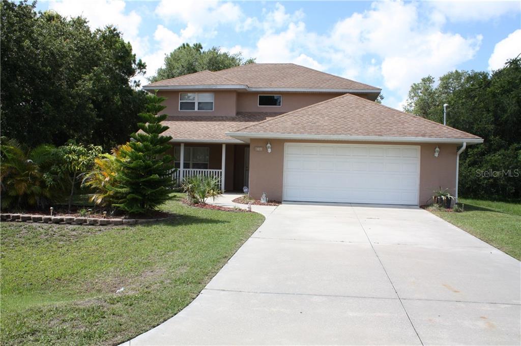 127 Venice Road Rotonda West, FL 33947 - Photo 1 of 1 a front view of house with yard and green space