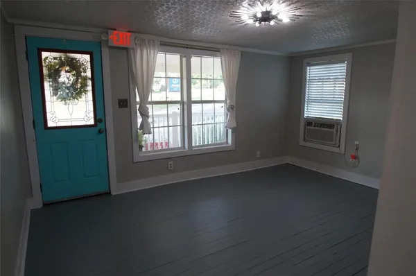 an empty room with a empty space and windows
