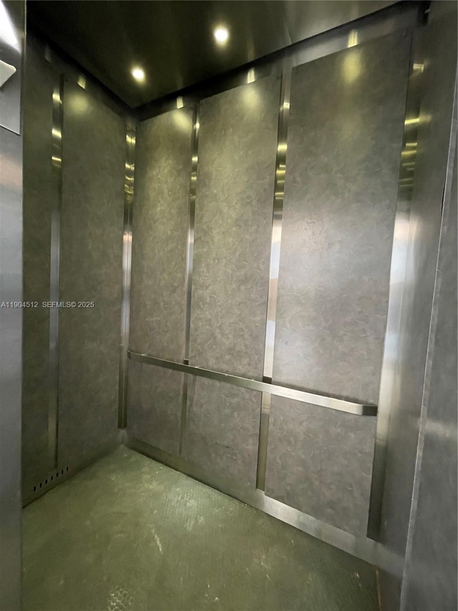 1670 Bay Road, Unit 2B Miami Beach, FL 33139 - Photo 14 of 15 a bathroom with a glass shower door