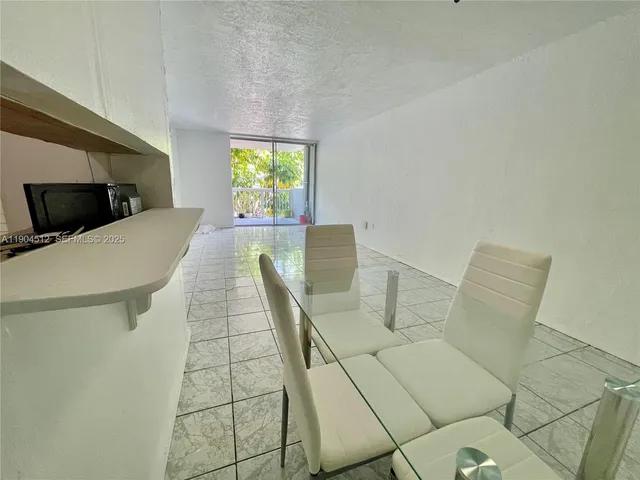 a kitchen with a refrigerator a stove top oven and cabinets