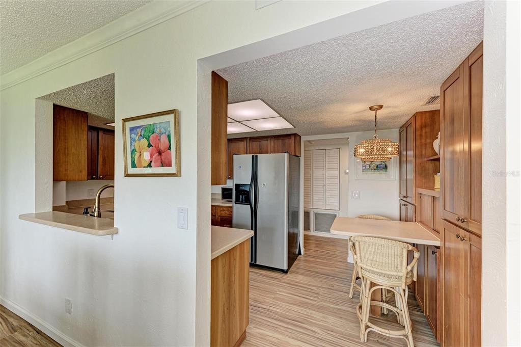 8735 Midnight Pass Road, Unit 107B Sarasota, FL 34242 - Photo 15 of 55 a view of a hallway with furniture and wooden floor
