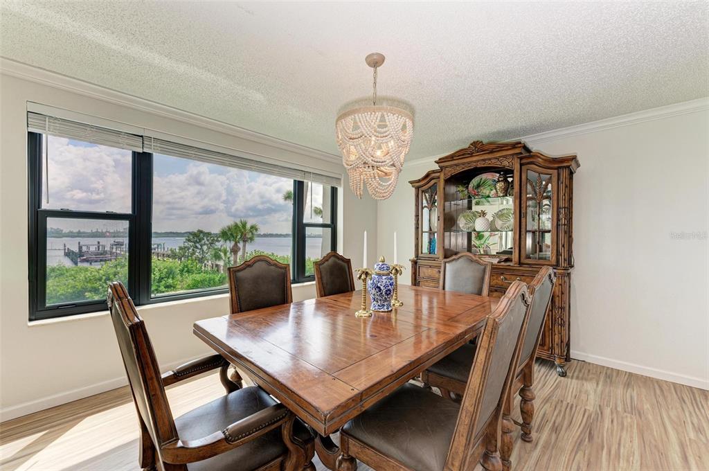 8735 Midnight Pass Road, Unit 107B Sarasota, FL 34242 - Photo 16 of 55 a view of a dining room with furniture window and wooden floor