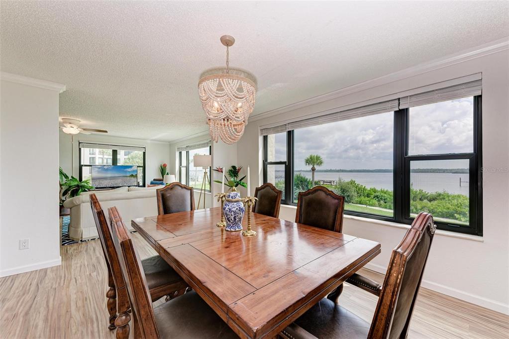 8735 Midnight Pass Road, Unit 107B Sarasota, FL 34242 - Photo 17 of 55 a view of a dining room with furniture window and wooden floor