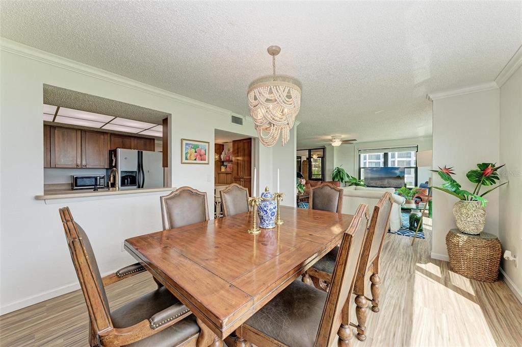 8735 Midnight Pass Road, Unit 107B Sarasota, FL 34242 - Photo 18 of 55 a view of a dining room with furniture and wooden floor