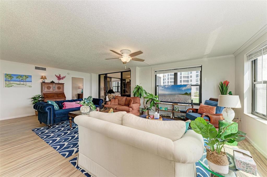 8735 Midnight Pass Road, Unit 107B Sarasota, FL 34242 - Photo 19 of 55 a living room with furniture and a chandelier