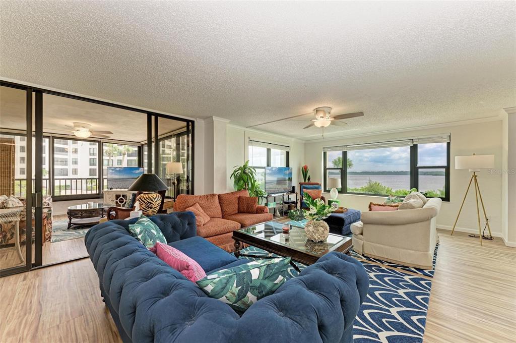 8735 Midnight Pass Road, Unit 107B Sarasota, FL 34242 - Photo 20 of 55 a living room with furniture and a large window