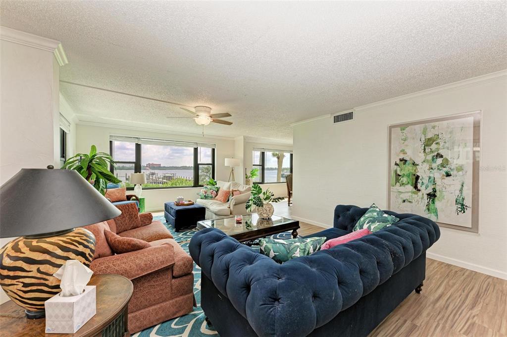 8735 Midnight Pass Road, Unit 107B Sarasota, FL 34242 - Photo 21 of 55 a living room with furniture and a large window