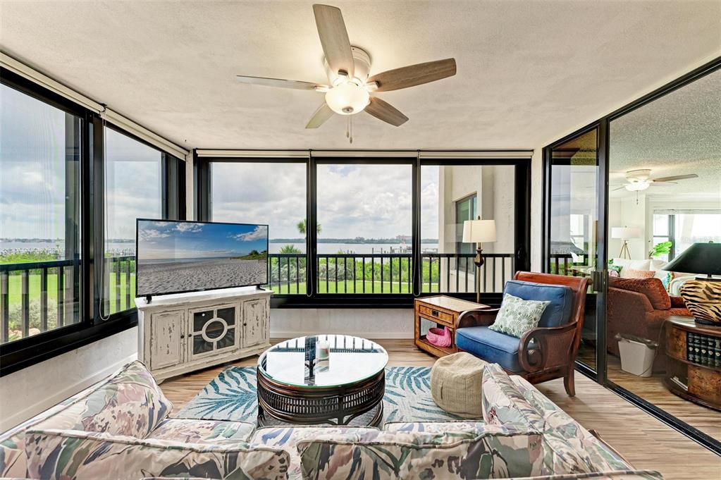 8735 Midnight Pass Road, Unit 107B Sarasota, FL 34242 - Photo 23 of 55 a living room with furniture and a large window