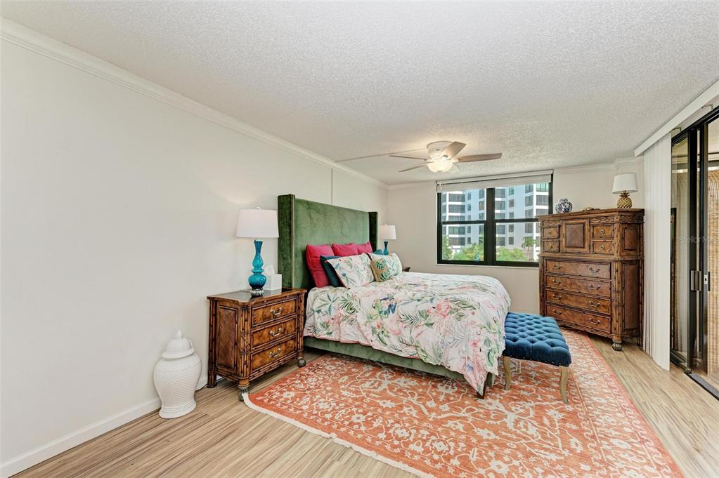 8735 Midnight Pass Road, Unit 107B Sarasota, FL 34242 - Photo 25 of 55 a bedroom with a bed and a window