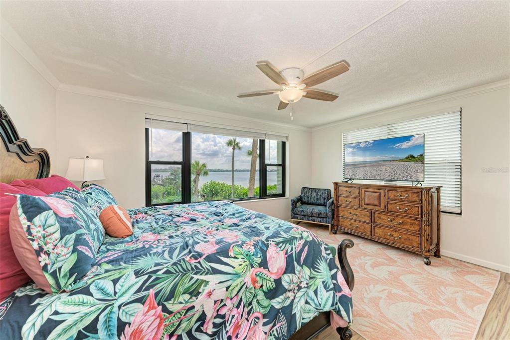 8735 Midnight Pass Road, Unit 107B Sarasota, FL 34242 - Photo 30 of 55 a bedroom with a bed and a window