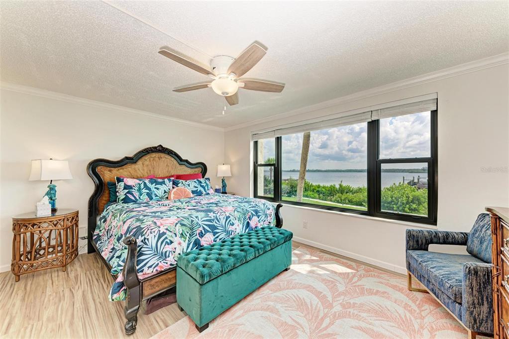 8735 Midnight Pass Road, Unit 107B Sarasota, FL 34242 - Photo 31 of 55 a bedroom with a bed and a large window with outer view