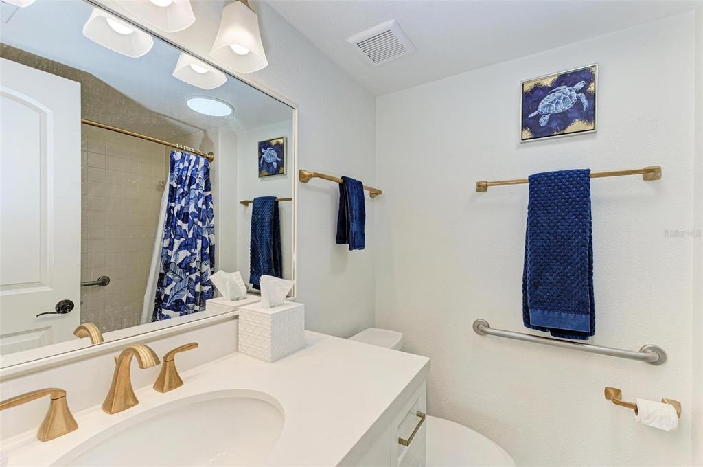 8735 Midnight Pass Road, Unit 107B Sarasota, FL 34242 - Photo 34 of 55 a bathroom with a sink and a mirror