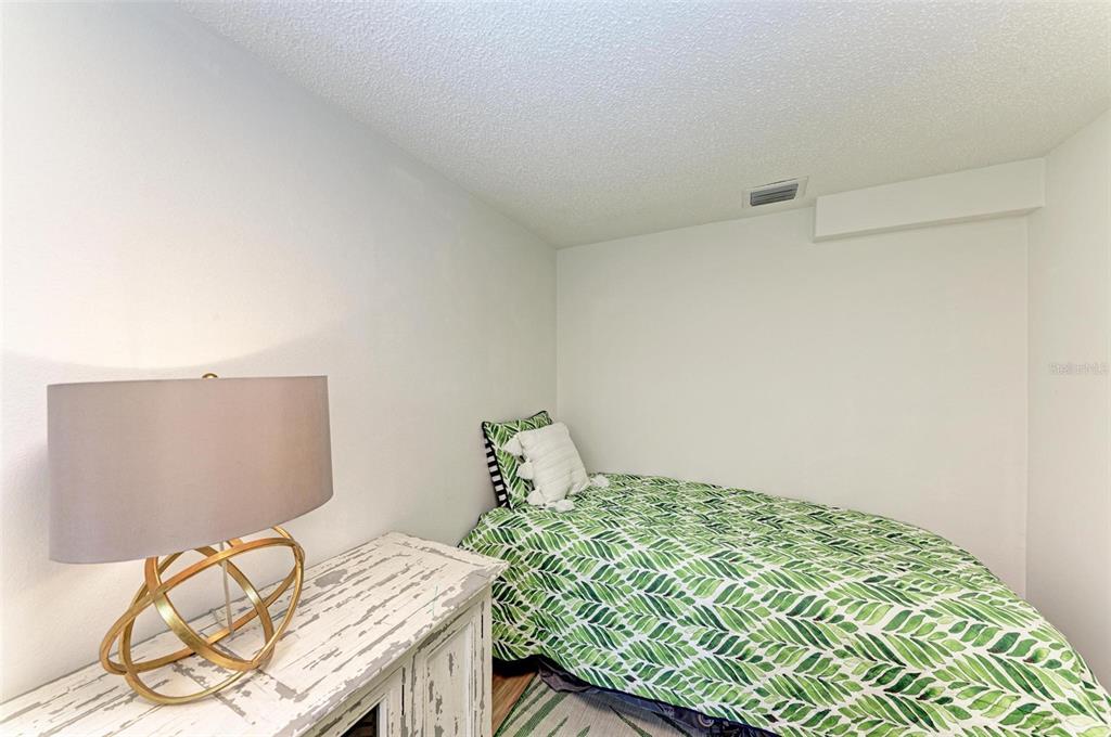 8735 Midnight Pass Road, Unit 107B Sarasota, FL 34242 - Photo 37 of 55 a bedroom with a bed and a window