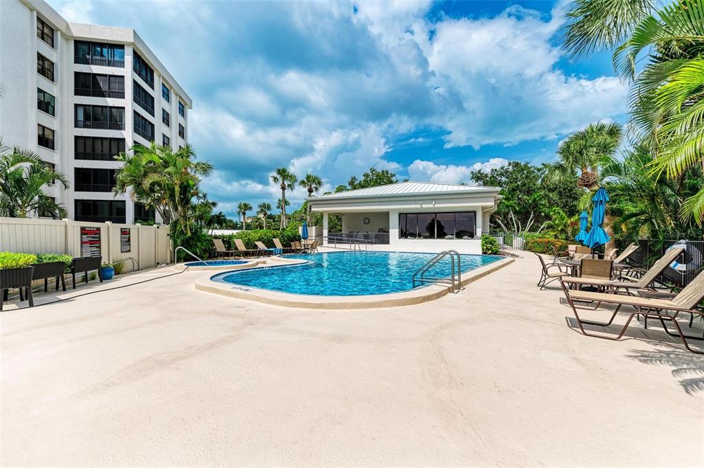 8735 Midnight Pass Road, Unit 107B Sarasota, FL 34242 - Photo 44 of 55 a view of house with swimming pool and sitting area