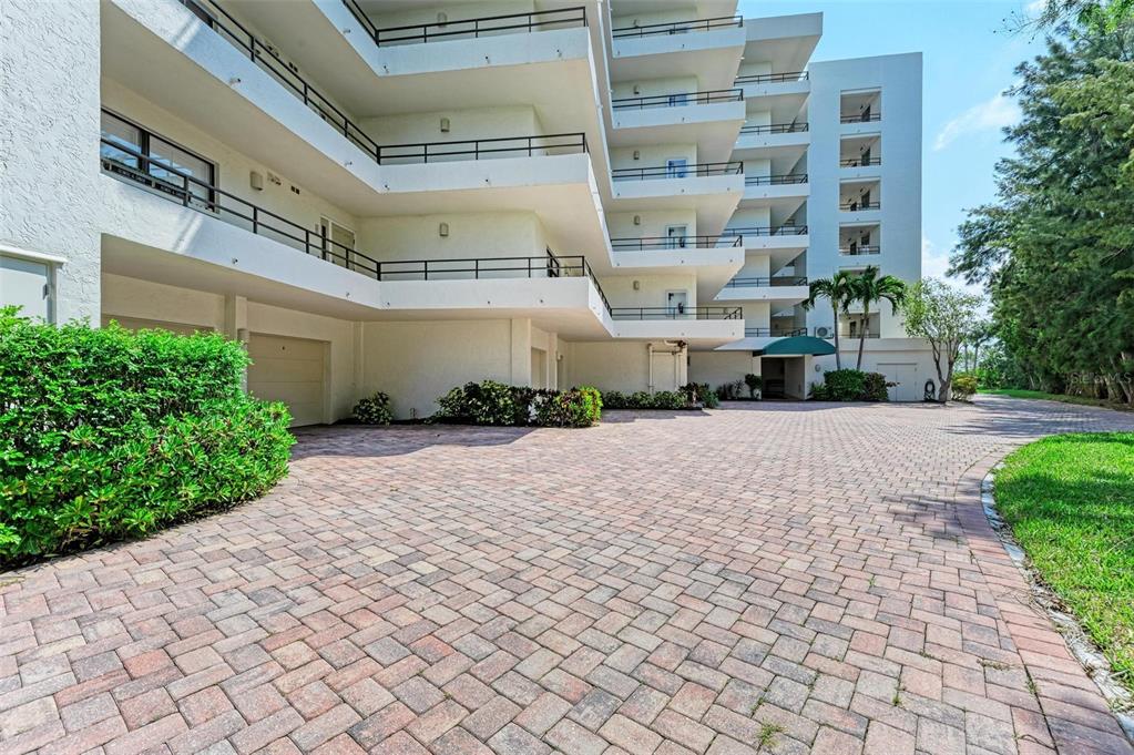 8735 Midnight Pass Road, Unit 107B Sarasota, FL 34242 - Photo 7 of 55 a front view of a building with a yard