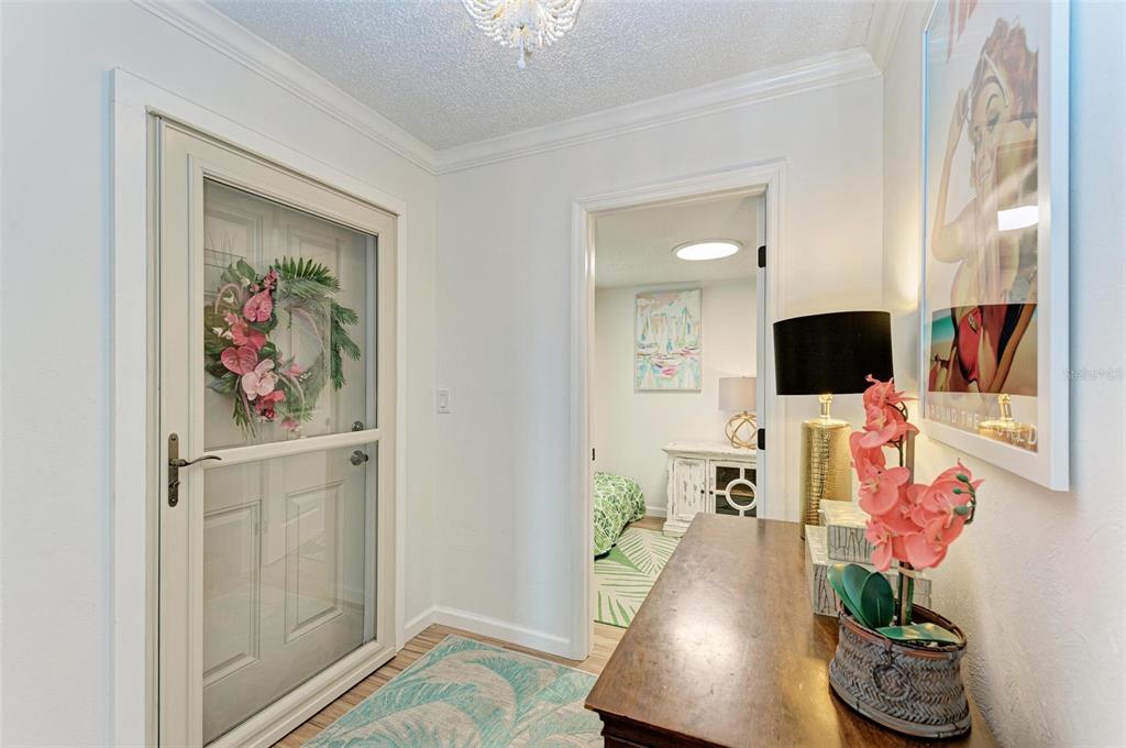 8735 Midnight Pass Road, Unit 107B Sarasota, FL 34242 - Photo 8 of 55 a living room with furniture and a flat screen tv