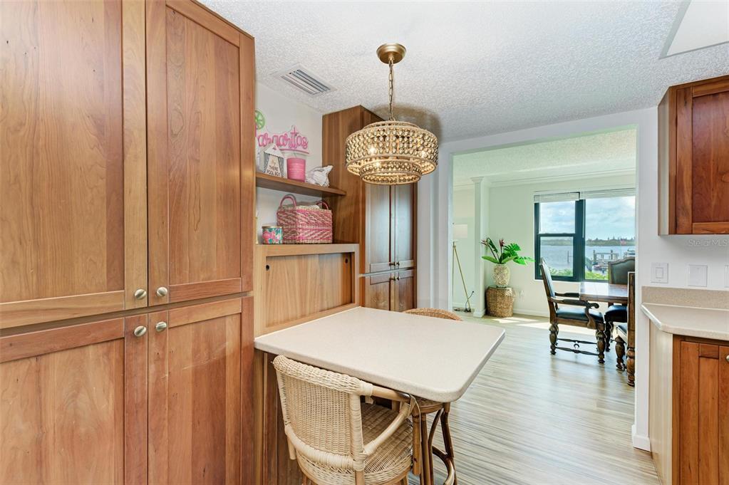 8735 Midnight Pass Road, Unit 107B Sarasota, FL 34242 - Photo 10 of 55 a view of a dining room with furniture window and wooden floor
