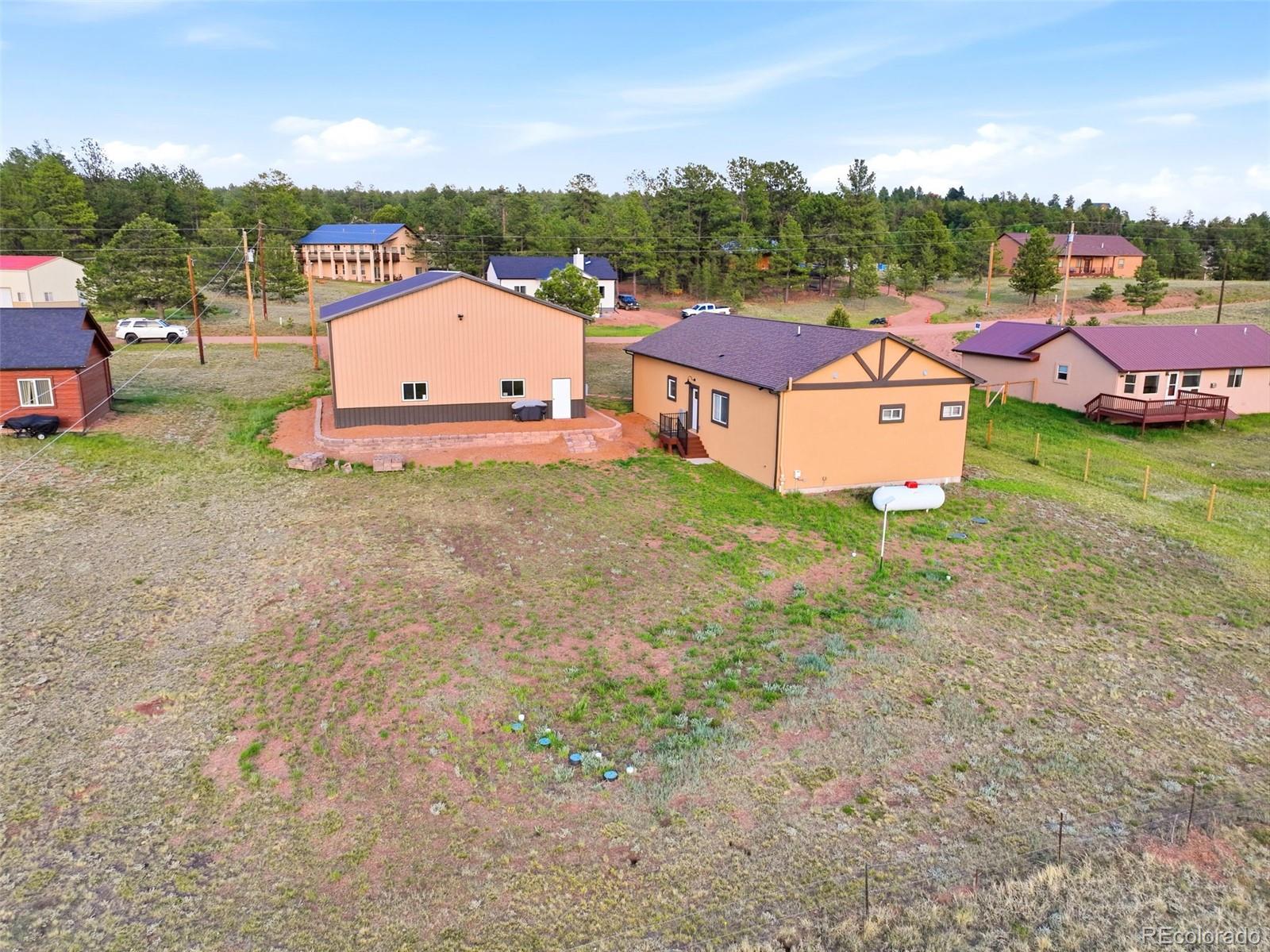 489 Duesouth Road Florissant, CO 80816 - Photo 3 of 40 an aerial view of a house with backyard space and lake view
