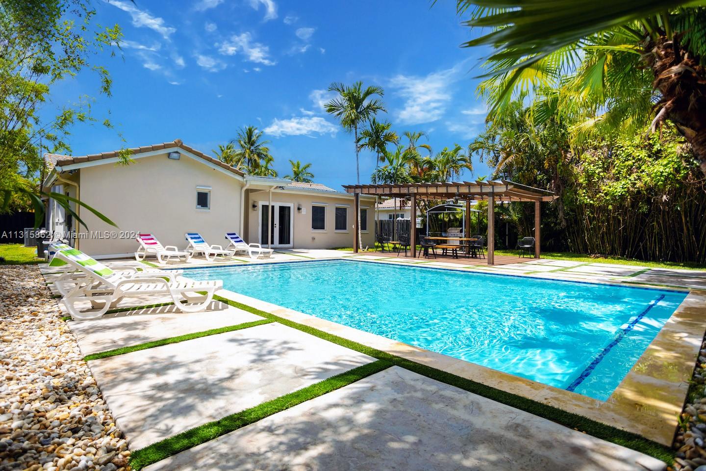 a view of house with swimming pool