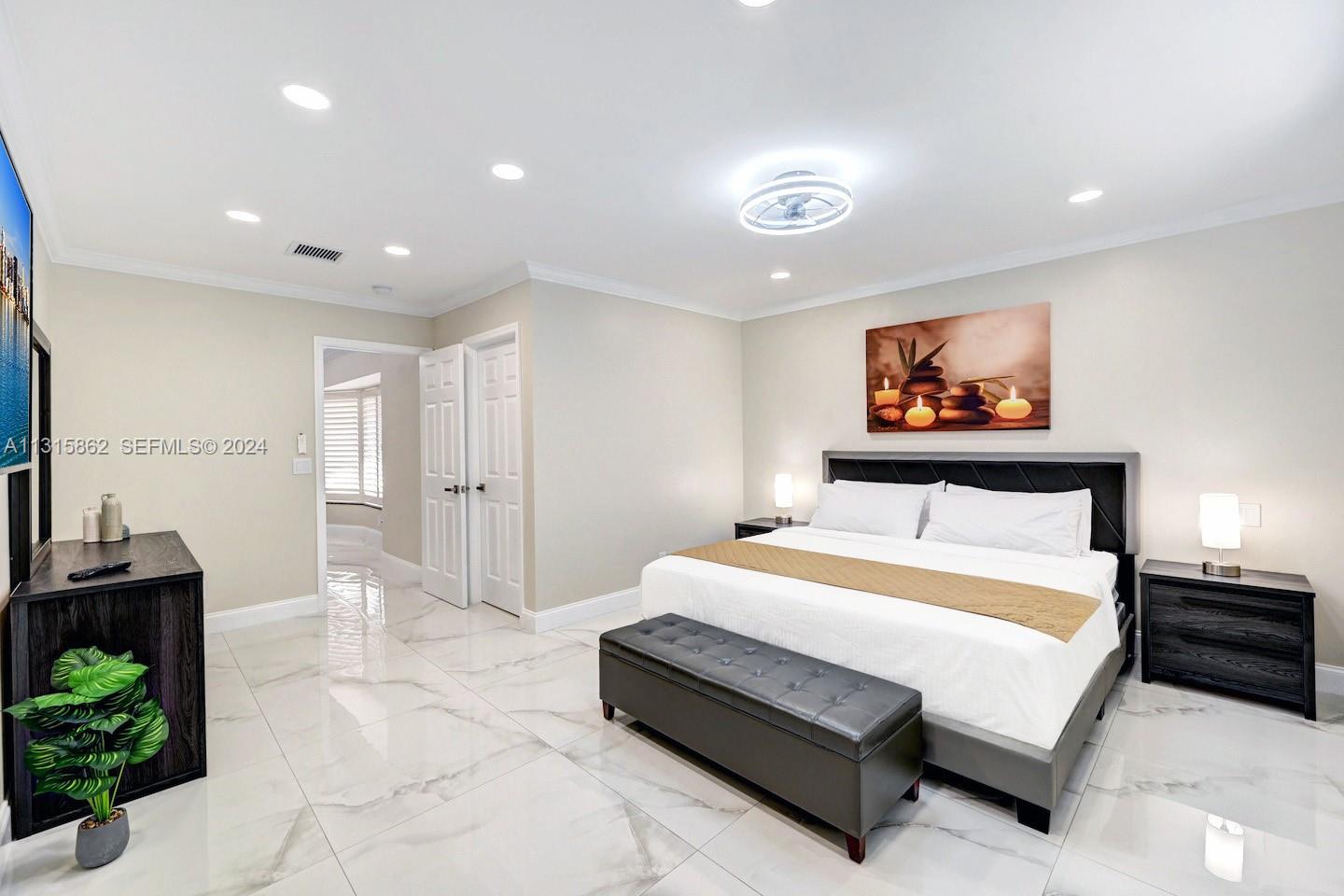 1307 Rodman Street Hollywood, FL 33019 - Photo 17 of 38 a spacious bedroom with a bed and a painting on the wall