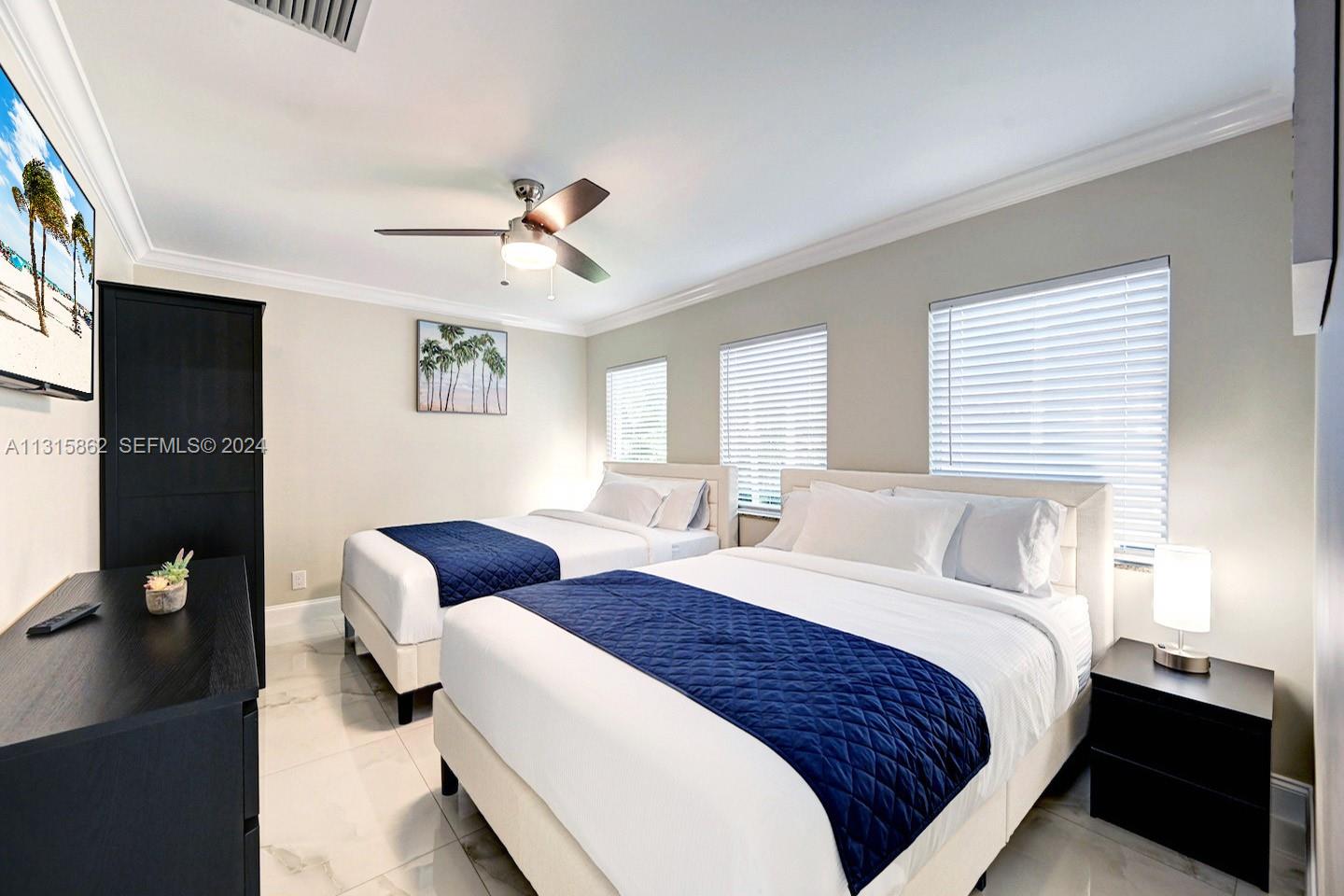 1307 Rodman Street Hollywood, FL 33019 - Photo 18 of 38 a bedroom with bed and window