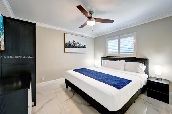 a bed sitting in a bedroom next to a window