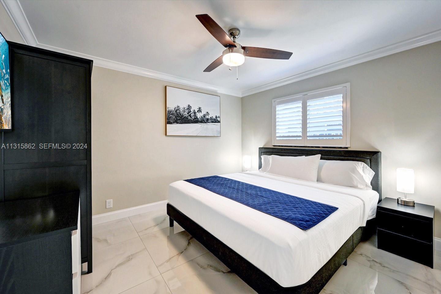 1307 Rodman Street Hollywood, FL 33019 - Photo 20 of 38 a bed sitting in a bedroom next to a window