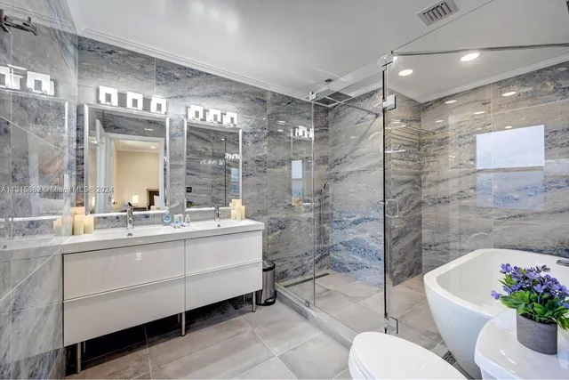 a bathroom with a toilet bathtub and shower
