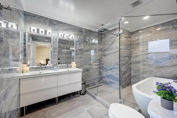 a bathroom with a toilet bathtub and shower