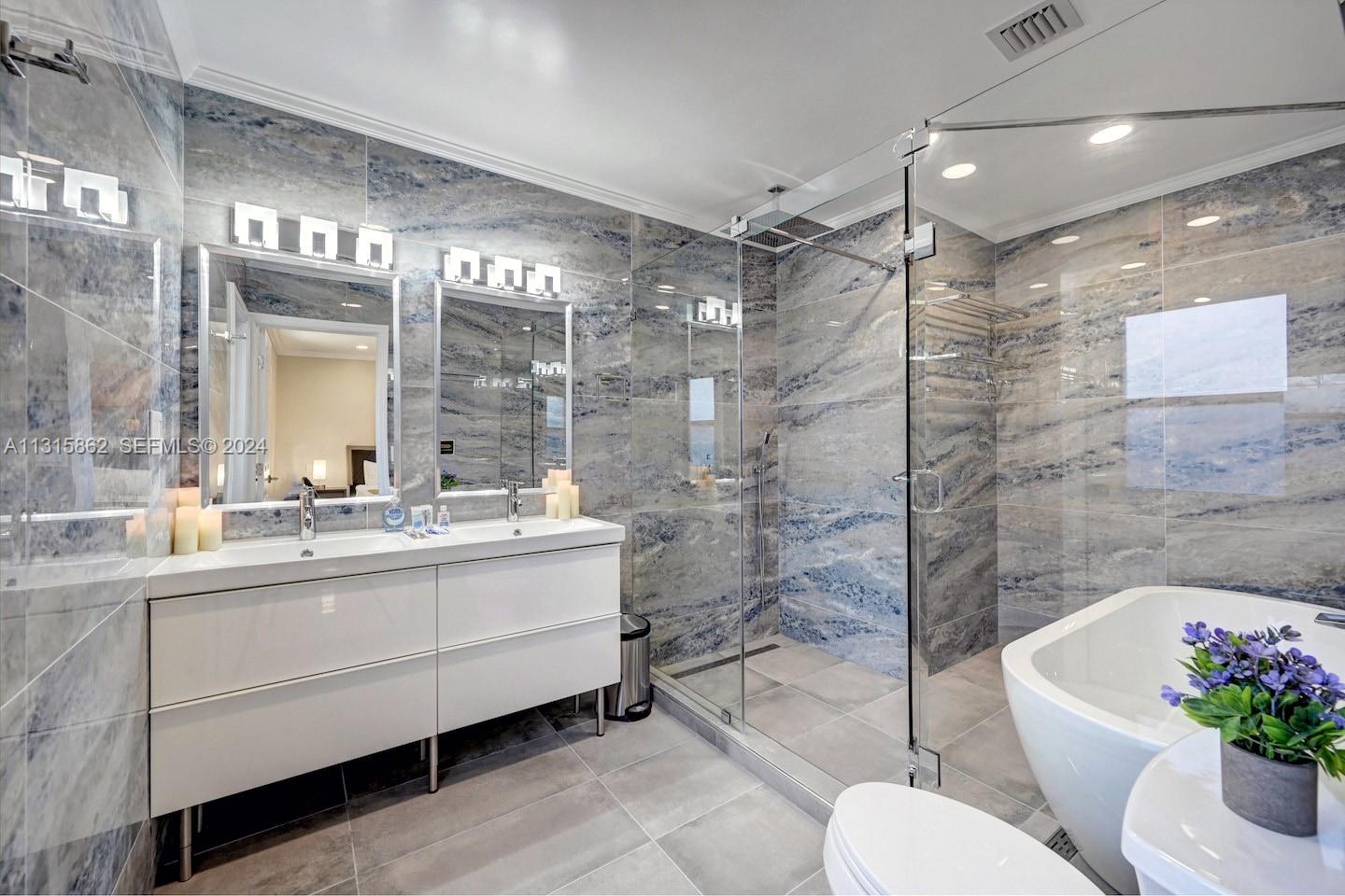 1307 Rodman Street Hollywood, FL 33019 - Photo 30 of 38 a bathroom with a double vanity sink toilet and shower