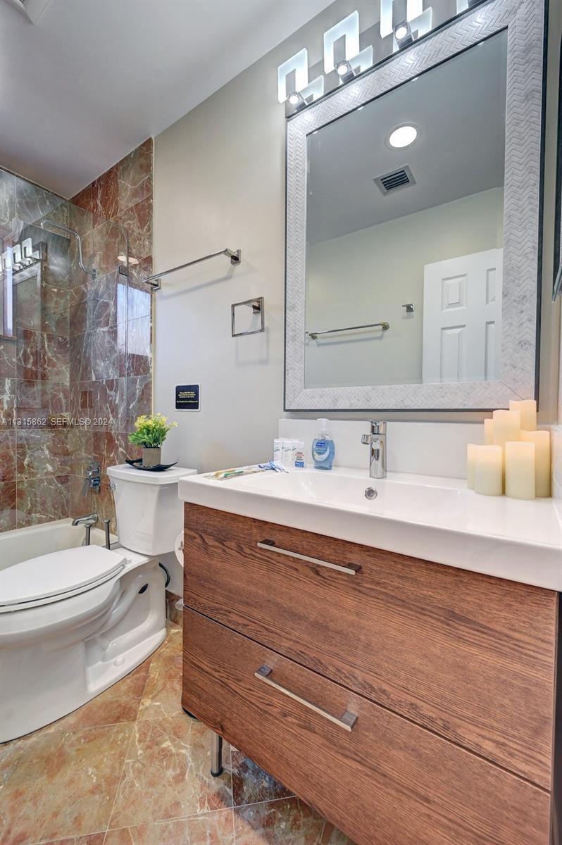 1307 Rodman Street Hollywood, FL 33019 - Photo 34 of 38 a bathroom with a sink a toilet a mirror and shower